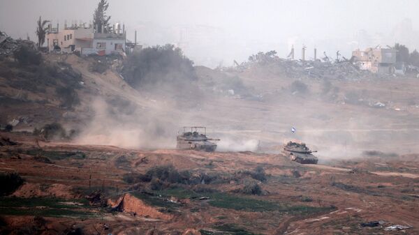 This picture taken on January 9, 2024 from the Israeli border with the Gaza Strip shows Israeli army tanks rolling in the center of the Gaza Strip, amid the ongoing battles between Israel and the militant Hamas group - Sputnik International