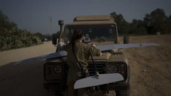 An Israeli soldier checks a reconnaissance drone to ensure it's in working order somewhere near the Israel-Gaza border, January 2024. - Sputnik International