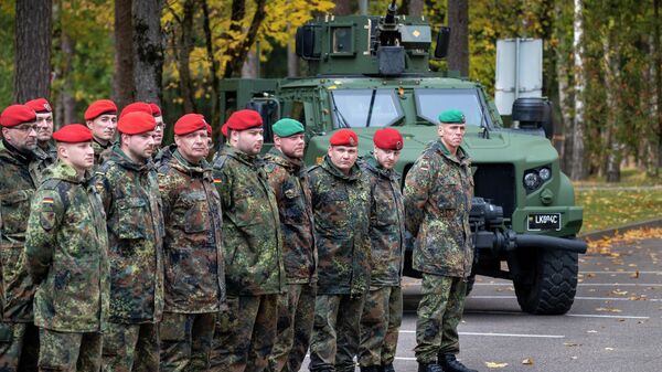 Soldiers of the German Bundeswehr 41st Mechanized Infantry Brigade Forward Command Element wait to greet German Defense Minister Christine Lambrecht upon her arrival at the Rukla military base some 100 kms (62.12 miles) west of the capital Vilnius, Lithuania, Saturday, Oct. 8, 2022. - Sputnik International