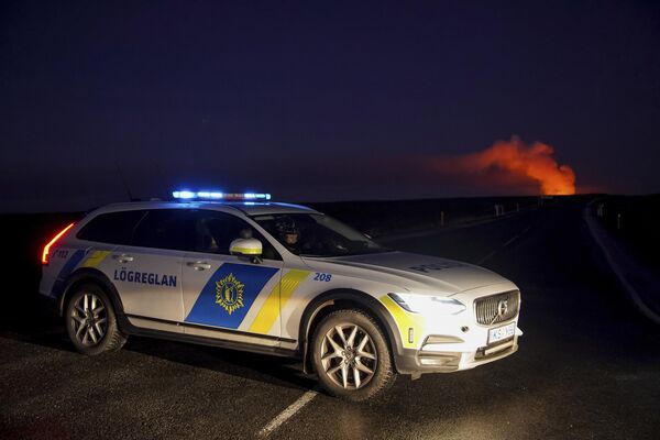 A police car blocks the access to the road that leads to Grindavík, after a volcano erupted. - Sputnik International
