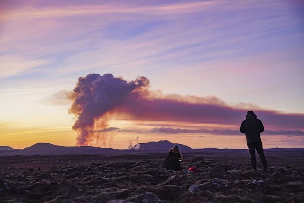 People watch from the north as the volcano erupts near Grindavík. - Sputnik International