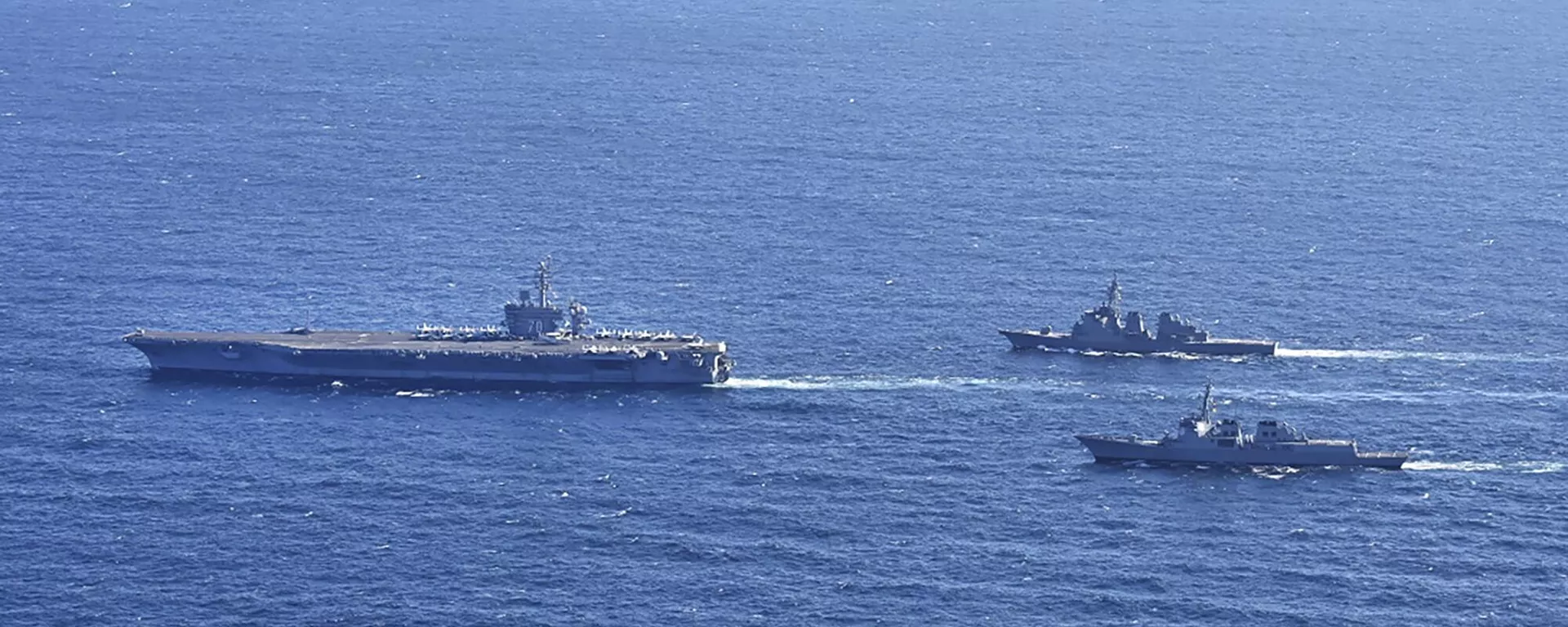 Aircraft carrier USS Carl Vinson, left, sails with South Korean Navy's Aegis destroyer King Sejong the Great and Japan's Maritime Self-Defense Force Aegis destroyer Kongou in the international waters of the southern coast of Korean peninsular during a recent joint drill in 2024 - Sputnik International, 1920, 17.01.2024