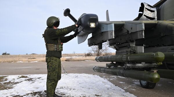 A serviceman of the Centr combat group of the Russian Armed Forces prepares a Ka-52 reconnaissance and attack helicopter for a flight in the zone of a special military operation. - Sputnik International
