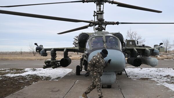 Russian Armed Forces Ka-52 reconnaissance and attack helicopter being prepared for a flight in the zone of a special military operation. - Sputnik International