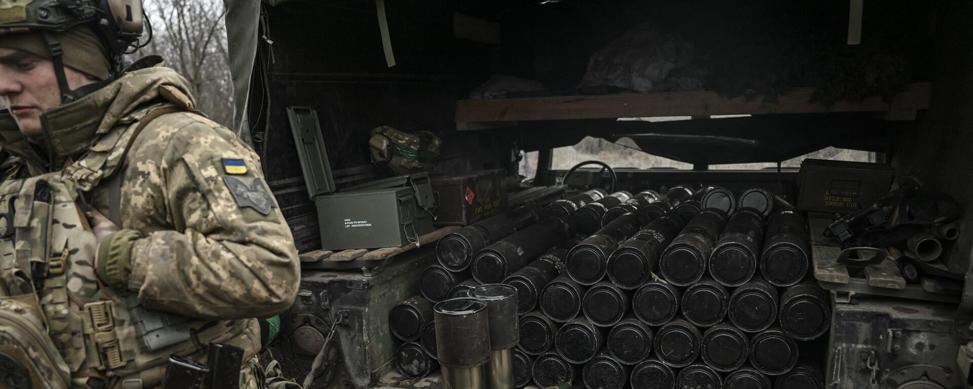 A Ukrainian serviceman stands next to a truck loaded with shells of a 105mm howitzer near Artemovsk, Donetsk People's Republic. File photo - Sputnik International, 1920, 28.01.2024
