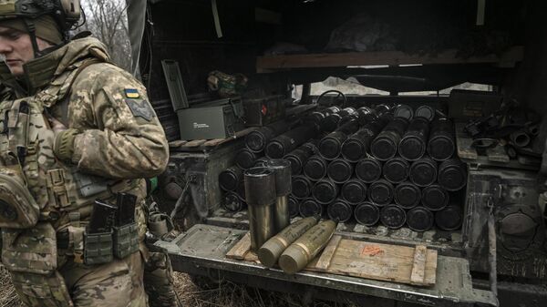 A Ukrainian serviceman stands next to a truck loaded with shells of a 105mm howitzer near Artemovsk, Donetsk People's Republic. File photo - Sputnik International