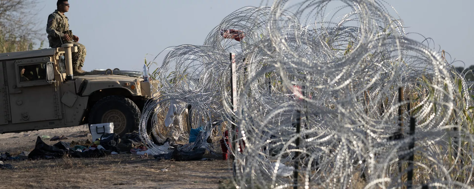 A member of the Texas National Guard looks on as he monitors the Rio Grande river for migrants at the US-Mexico border in Eagle Pass, Texas on September 23, 2023 - Sputnik International, 1920, 27.01.2025