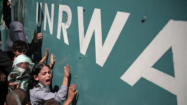 In this Sunday, Aug. 16, 2015 file photo, a Palestinian school girl chants slogans during a demonstration against an UNRWA funding gap that could keep about 500,000 Palestinian students out of school this fall, outside the UNRWA Gaza Headquarters in Gaza City. - Sputnik International