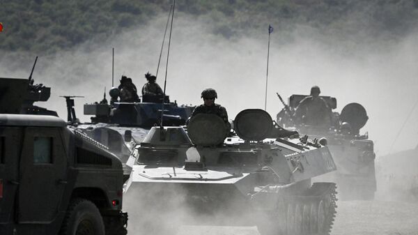 Servicemen drive armoured vehicles as they take part in the NATO Noble Blueprint 23 joint military exercise at the Novo Selo military ground, northwestern Bulgaria, on September 26, 2023.  - Sputnik International