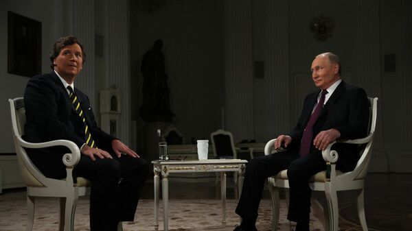 Russian President Vladimir Putin and US journalist Tucker Carlson are seen during an interview at the Kremlin in Moscow, Russia. - Sputnik International