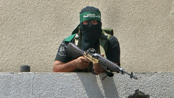 A Palestinian gunman from Hamas sits in a position in Gaza City, Wednesday, June 13, 2007 - Sputnik International