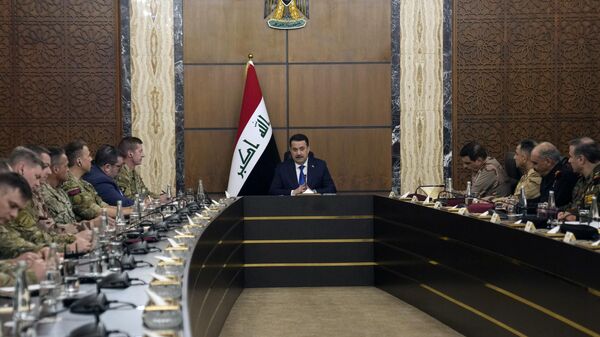 Iraqi Prime Minister Mohamed Shia al-Sudani (C) chairs a meeting with top-ranking officials of the Iraqi armed forces and of the US-led coalition during the first round of talks on the future of American and other foreign troops in the country, in Baghdad on January 27, 2024. Baghdad expects discussions to lead to a timeline for reducing their presence. Roughly 2,500 US troops are still deployed in Iraq. - Sputnik International
