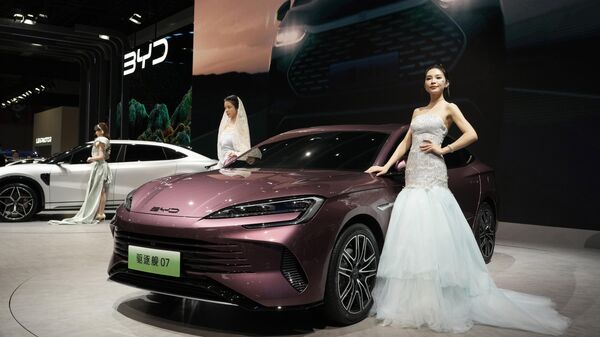 Models pose near the latest offering from Chinese automaker BYD during the Auto Shanghai 2023 show in Shanghai, Wednesday, April 19, 2023 - Sputnik International