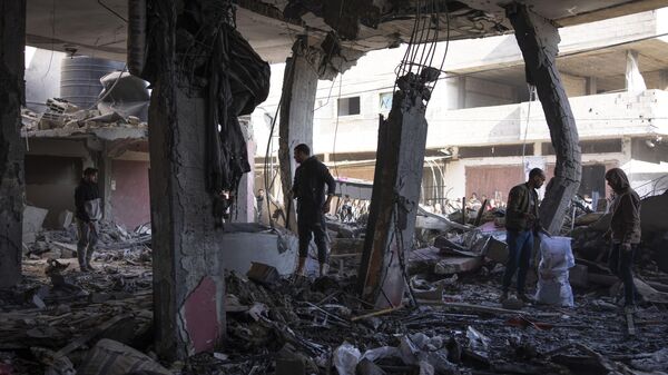 Palestinians check destruction after an Israeli strike in Rafah, Gaza Strip, Saturday, Feb. 24, 2024 - Sputnik International
