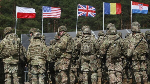 US troops, part of a NATO mission to enhance Poland's defence, are getting ready for an official welcoming ceremony in Orzysz, northeastern Poland, Thursday, April 13, 2017 - Sputnik International