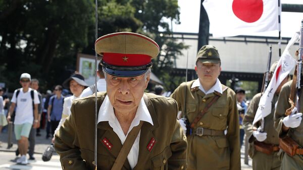 Japanese men clad in outdated military costumes march in to pay respects to the country's war dead at the Yasukuni Shrine in Tokyo, Saturday, Aug. 15, 2015 - Sputnik International