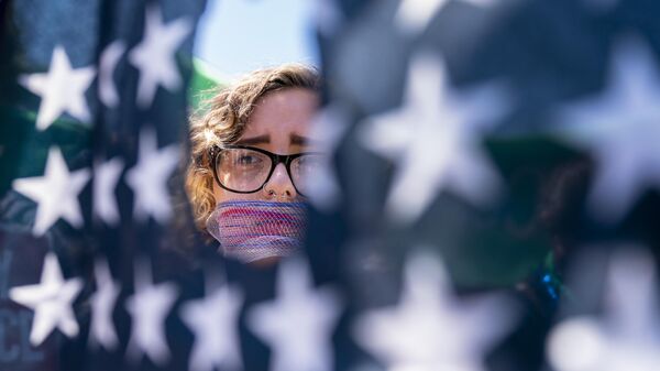 Emma Rousseau of Oakland, N.J., her mouth bound with a red, white and blue netting, attends a rally on the Fourth of July to protest for abortion rights, at Lafayette Park in front of the White House in Washington, Monday, July 4, 2022 - Sputnik International