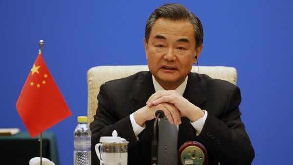 Chinese Foreign Minister Wang Yi speaks duriong the meeting of the Foreign Ministers of China, Russia and India at Diaoyutai State guesthouse in Beijing Monday, Feb. 2, 2015 - Sputnik International