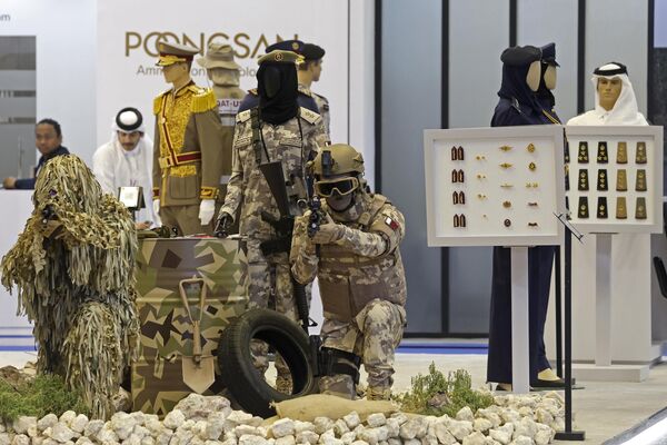 Exhibitors stand next to their pavilion of protective gear for military and police during the DIMDEX 2024.  - Sputnik International