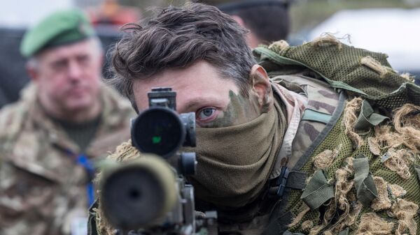 A British soldier looks into a telescopic sight as he holds his sniper rifle during the NATO DRAGON-24 military exercise in Korzeniewo, northern Poland - Sputnik International