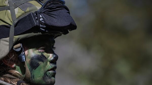 A female soldier of the P18 Gotland Regiment is pictured during a field exercise near Visby on the Swedish island of Gotland on May 17, 2022.  - Sputnik International