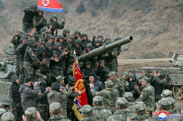 Kim Jong Un and tank crews near North Korea's new main battle tank. Photo: KCNA. 