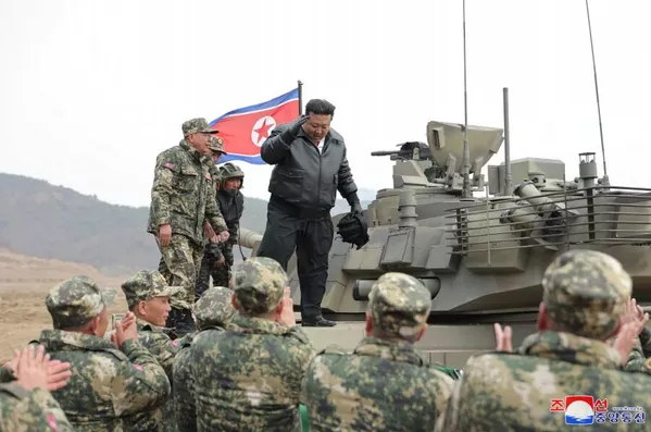 Kim Jong Un stands on a new main battle tank after a training competition. Photo: KCNA.