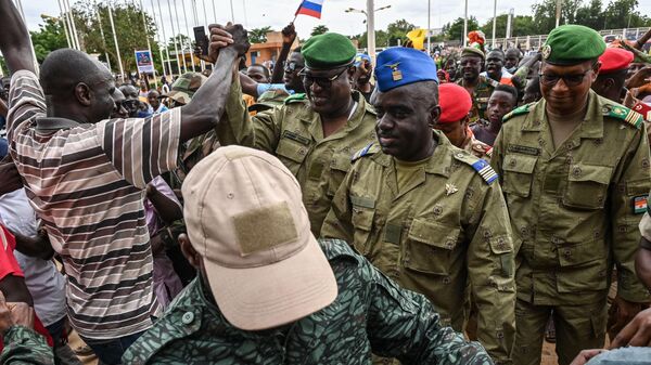 Niger's National Council for the Safeguard of the Homeland (CNSP) Colonel-Major Amadou Abdramane (C), General Mohamed Toumba (C-L) and Colonel Ousmane Abarchi (R) are greeted by supporters upon their arrival at the Stade General Seyni Kountche in Niamey Niger on August 6, 2023 - Sputnik International