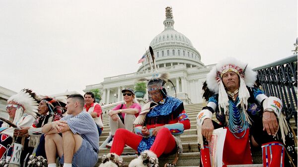 A group of American Indians, some of them dressed in their traditional garb, sit on the steps in front of the Capitol, in Washington, D.C., September 12, 1995, during the National Sovereignty Day Vigil. Tribes from across the country gathered on Capitol Hill to protest proposed cuts in federal spending on American Indian programs. - Sputnik International