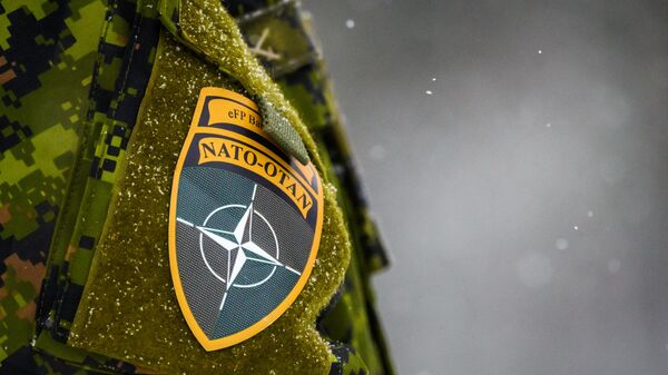 The NATO logo is seen on a uniform during the NATO annual military exercise Winter Shield 2021 in Adazi, Latvia, on November 29, 2021. - Sputnik International