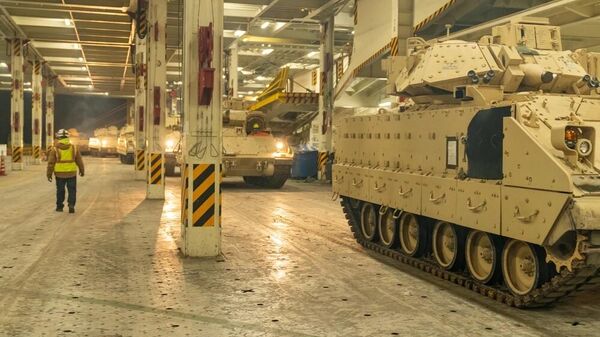 A convoy of Bradley Fighting Vehicles load onto the ARC Integrity Jan. 25, 2023, at the Transportation Core Dock in North Charleston, South Carolina. More than 60 Bradleys were shipped by U.S. Transportation Command as part of the U.S. military aid package to Ukraine. - Sputnik International