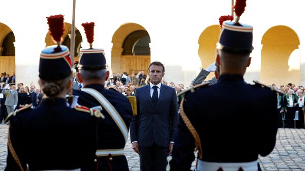 French President Emmanuel Macron (C) inspects the guard of honor as he attends a national homage for late French historian and perpetual secretary of the Academie Francaise (French Academy) Helene Carrere d'Encausse at the Invalides in Paris, on October 3, 2023. - Sputnik International