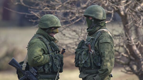 Pro-Russian soldiers stands outside the Ukrainian infantry base in Perevalne, Ukraine, Wednesday, March 12, 2014 - Sputnik International
