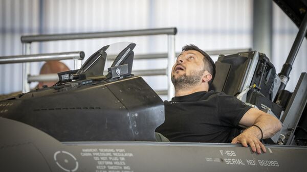 Ukrainian President Volodymyr Zelensky sits in a F-16 fighter jet in the hangar of the Skrydstrup Airbase in Vojens, northern Denmark, on August 20, 2023. Washington has told Denmark and the Netherlands that they will be permitted to hand over their F-16 fighter jets to Ukraine when the country's pilots are trained to operate them, the US State Department said on August 18, 2023. Both Denmark and the Netherlands are leading the program to train Ukraine's pilots on the F-16. - Sputnik International