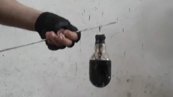 A screenshot of a video in which the Russian military shows chemical weapons used by Ukrainian forces. - Sputnik International