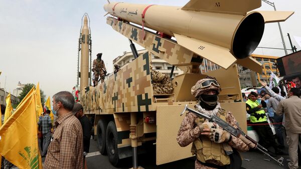 Iranian soldiers stand next to a Kheibar missile (R) and a Shahab-3 missile (L) during a rally marking al-Quds (Jerusalem) day, in street at the capital Tehran, on April 29, 2022.  - Sputnik International