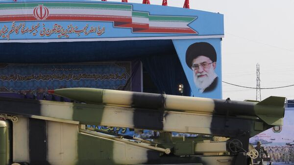 An Iranian military truck carries missiles past a portrait of Iran's Supreme Leader Ayatollah Ali Khamenei during a parade on the occasion of the country's annual army day on April 18, 2018 in Tehran. - Sputnik International