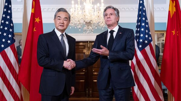 US Secretary of State Antony Blinken shakes hands with Chinese Foreign Minister Wang Yi prior to meetings at the State Department in Washington, DC, October 26, 2023. - Sputnik International