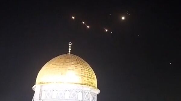 An image-grab from a video taken early on April 14, 2024, shows rocket trails in the sky above the Al-Aqsa Mosque compound in Jerusalem. Iran launched its first-ever direct attack on Israeli territory late on April 13 in response to Israel's April 1 attack targeting the Iranian Embassy compound in Damascus, Syria. - Sputnik International