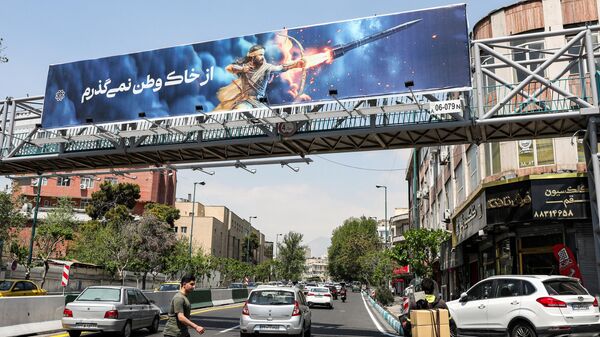 A banner depicting the mythical Persian hero Arash the archer firing a missile from his bow, with text in Persian reading I will not abandon my homeland, hangs on a suspended pedestrian bridge crossing in central Tehran on April 15, 2024. Iran on April 14 urged Israel not to retaliate militarily to an unprecedented attack overnight, which Tehran presented as a justified response to a deadly strike on its consulate building in Damascus. - Sputnik International