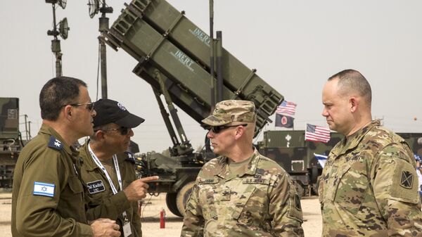 US and Israeli army officers talk in front a US Patriot missile defence system during the Israeli-US military exercise Juniper Cobra at the Hatzor Airforce Base in Israel. File photo. - Sputnik International