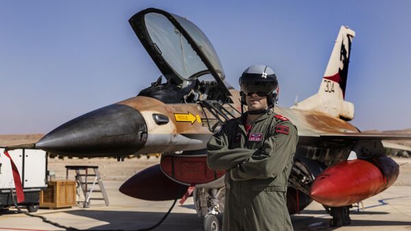 An Israeli F-16 pilot pose for a photo during the bi-annual multi-national aerial exercise known as the Blue Flag, at Ovda airbase near Eilat, southern Israel, Sunday, Oct. 24, 2021 - Sputnik International