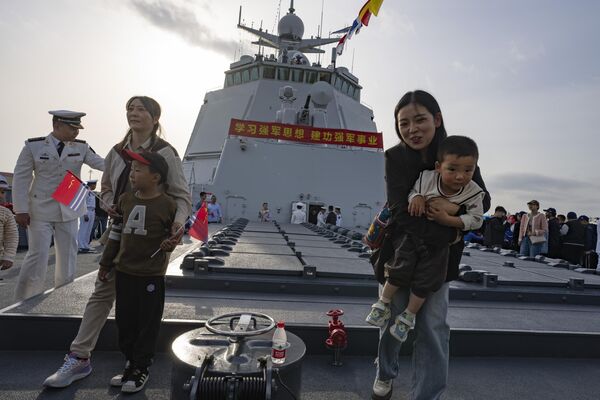 Visitors pose for photos near the vertical launching system on Chinese guided missile destroyer the Guiyang during a public day to mark the upcoming 75th anniversary of Chinese People&#x27;s Liberation Army Navy. - Sputnik International