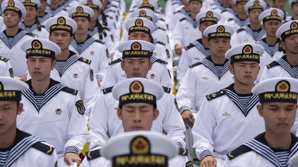 Chinese sailors sit in rows, a day before the opening of the West Pacific Naval Symposium in Qingdao in eastern China's Shandong province. - Sputnik International
