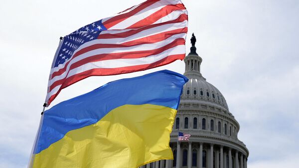 The American and Ukrainian flags wave in the wind outside of the Capitol on Tuesday, April 23, 2024, in Washington. The Senate is moving ahead with $95 billion in war aid to Ukraine, Israel and Taiwan. (AP Photo/Mariam Zuhaib) - Sputnik International