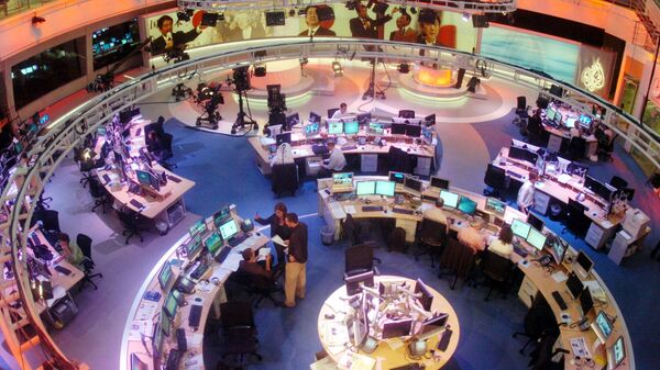 In This Tuesday, Nov. 14, 2006 file photo, Al Jazeera English Channel staff prepare for the broadcast inside the news room in Doha, Qatar. Al-Jazeera, the Qatar-based broadcaster, said Sunday, March 27, 2016 - Sputnik International