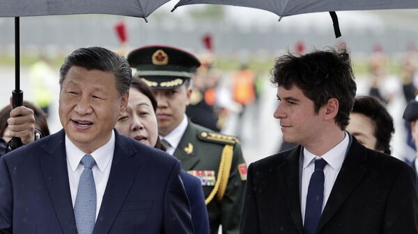 France's Prime Minister Gabriel Attal (R) greets China's President Xi Jinping upon his arrival for an official two-day state visit, at Orly airport, south of Paris on May 5, 2024 - Sputnik International