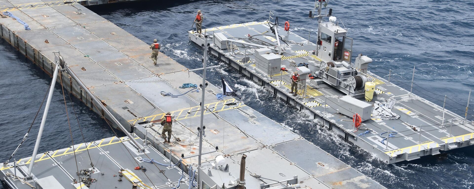 In this image provided by the U.S. Army, soldiers assigned to the 7th Transportation Brigade (Expeditionary) and sailors attached to the MV Roy P. Benavidez assemble the Roll-On, Roll-Off Distribution Facility (RRDF), or floating pier, off the shore of Gaza in the Mediterranean Sea on April 26, 2024. (U.S. Army via AP) - Sputnik International, 1920, 07.05.2024