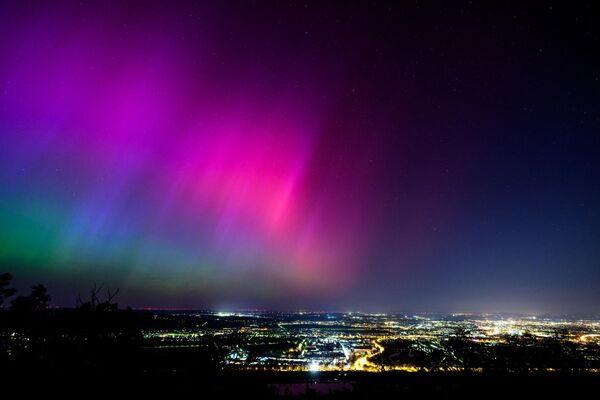 Northern lights or aurora borealis illuminate the night sky over Vienna during a geomagnetic storm on May 11, 2024. - Sputnik International