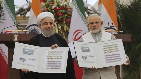 Indian Prime Minister Narendra Modi, right, with Iranian President Hassan Rouhani release a postal stamp commemorating growing economic and trade ties between the two nations in New Delhi, India, Saturday, Feb. 17, 2018 - Sputnik International